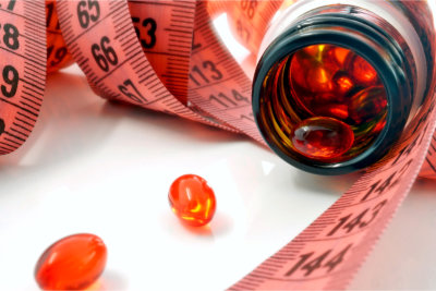 Measuring tape and bottle with pills